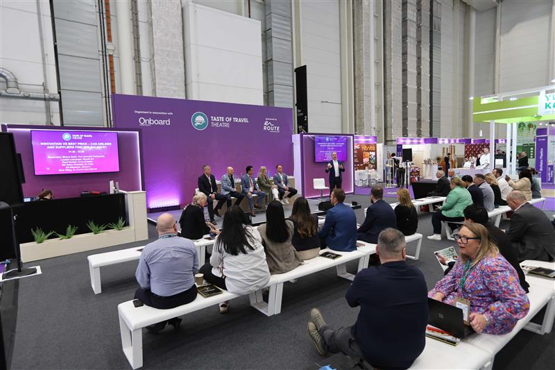 People listen to speakers at the Taste Of Travel booth during WTCE