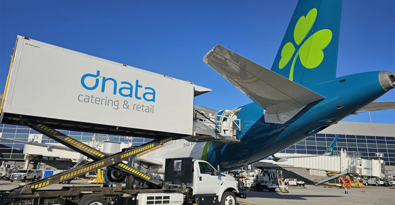 A dnata truck is loading supplies onto an Aer Lingus aircraft.