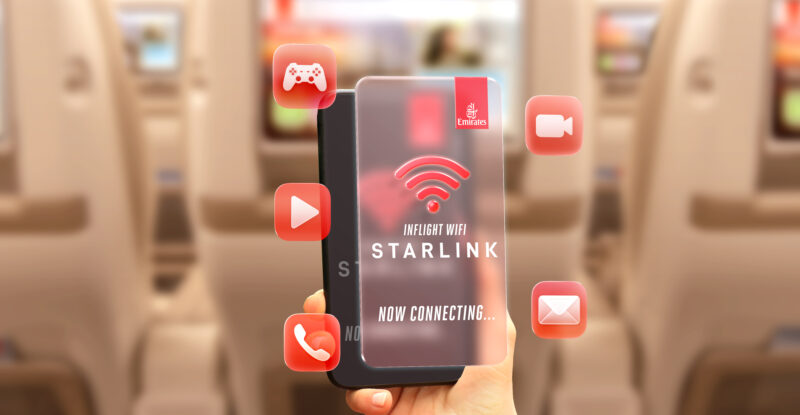 A passenger holds up their device in front of the Emirates IFE. The device says Starlink