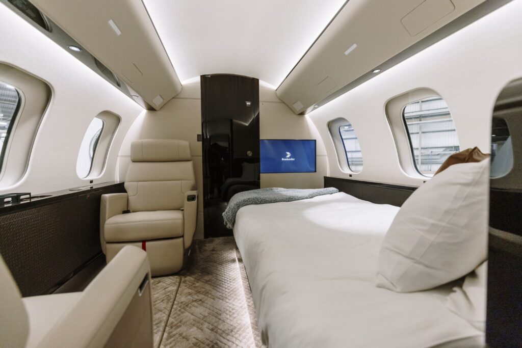 The principal suite is luxury with a large bed and seating. Image: Bombardier