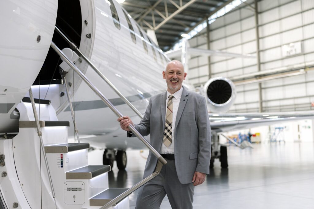 Stephen McCullough, Bombardier’s SVP Engineering & Product Development standing next to the Global 8000.