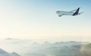 Lufthansa Airbus A320 in flight over the mountains.