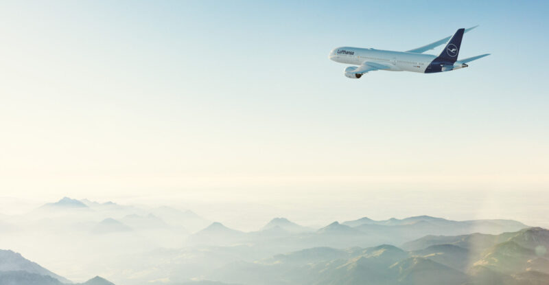 Lufthansa Airbus A320 in flight over the mountains.
