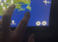 A passenger uses the FlightPath3D map on an aircraft