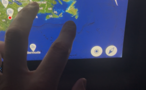 A passenger uses the FlightPath3D map on an aircraft