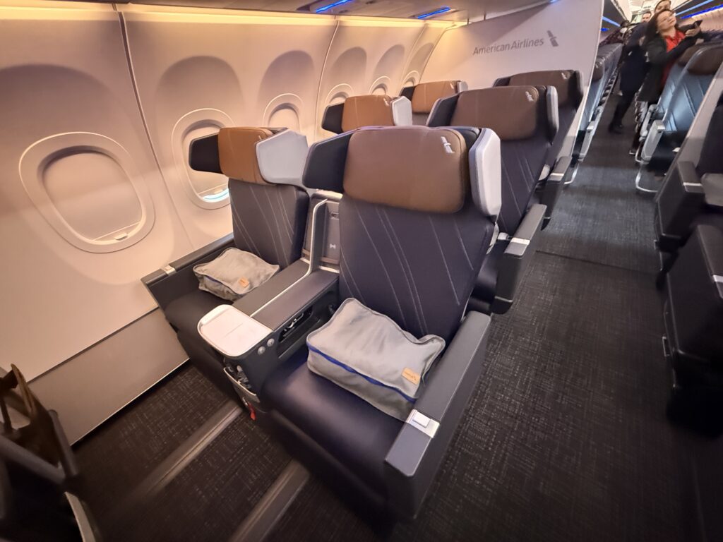 Front view of PE seats with blue seat covers, brown headrests and winged privacy.