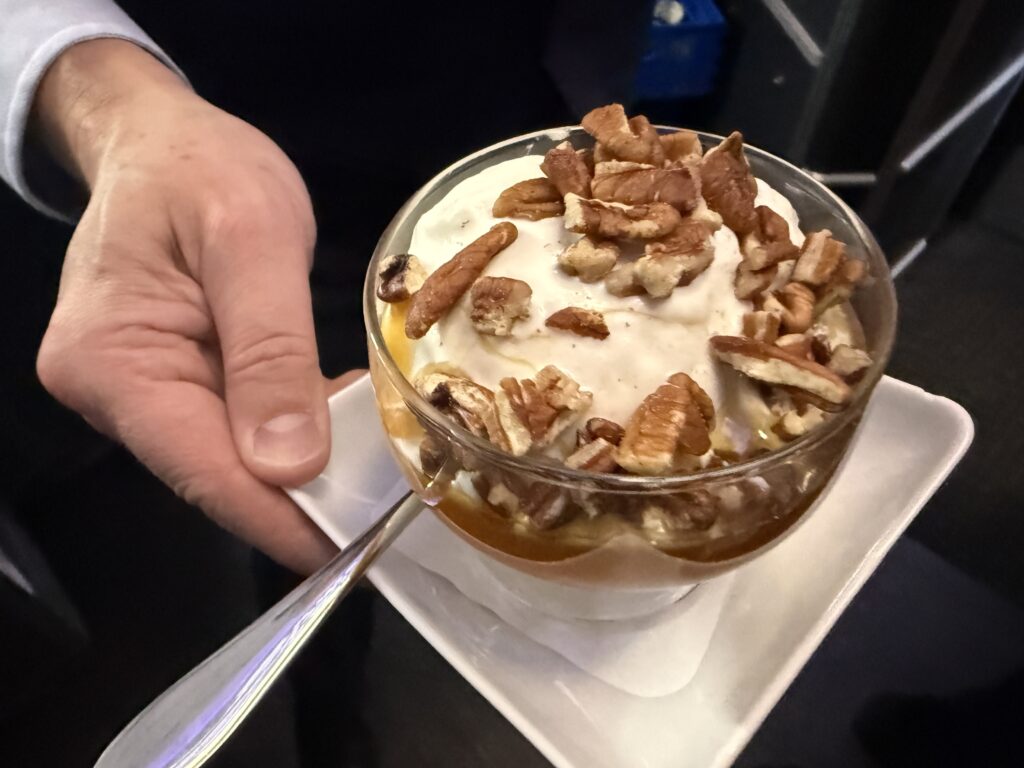 The signature American ice cream sundae with vanilla ice cream, hot fudge, butterscotch, seasonal berries, whipped cream and chopped pecans.