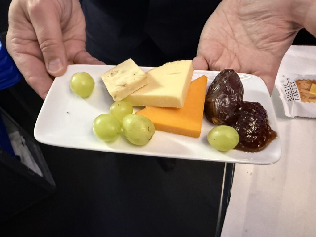 A gourmet cheese plate, served with fresh fruit and olive-oil sea-salt flatbread.