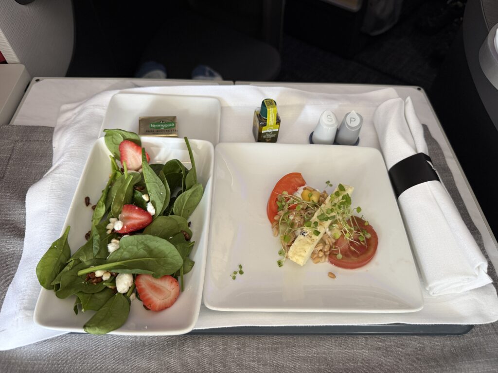 Grilled halloumi cheese with heirloom tomatoes and tabbouleh alongside a seasonal greens salad — with strawberries, goat cheese and roasted sunflower seeds.