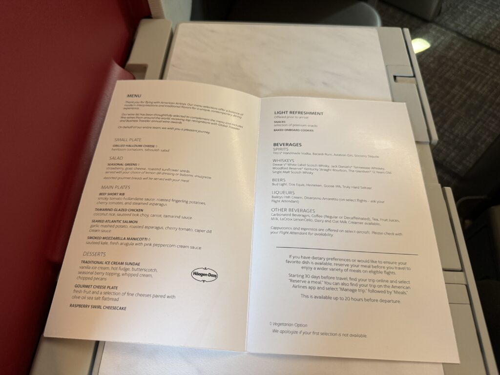 The Menu for American Airlines is displayed here open on the tray table. 