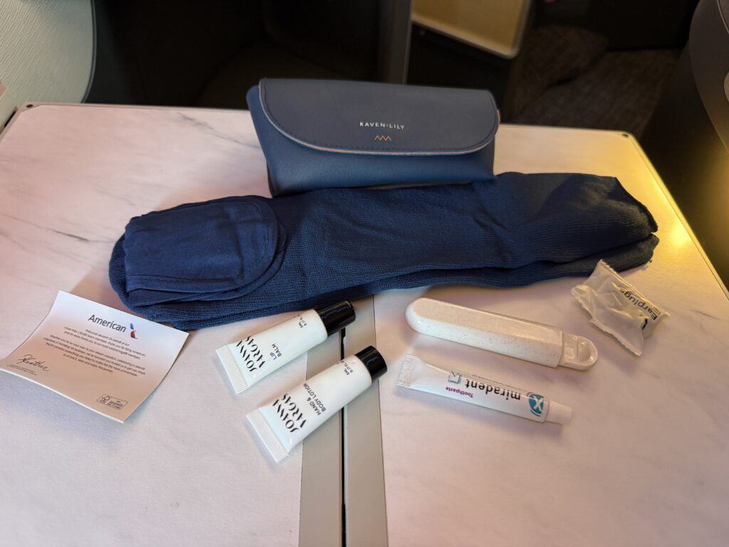 The American Airlines amenity kit contents are laying out on display. 