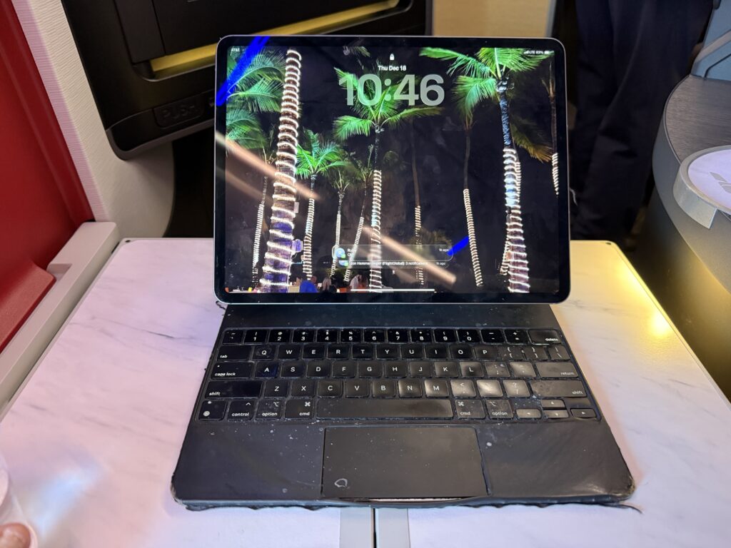 A laptop is seen here sitting on the suite tray table. 