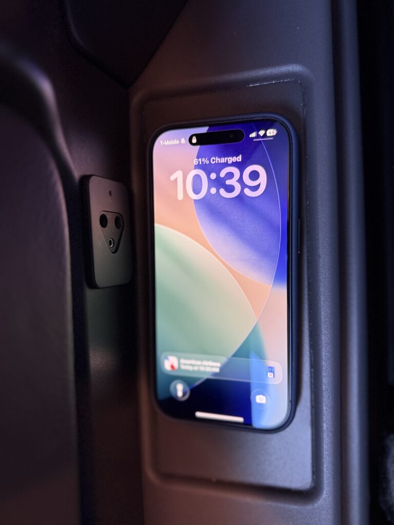 The passenger's phone is seen here charging on a wireless pad.