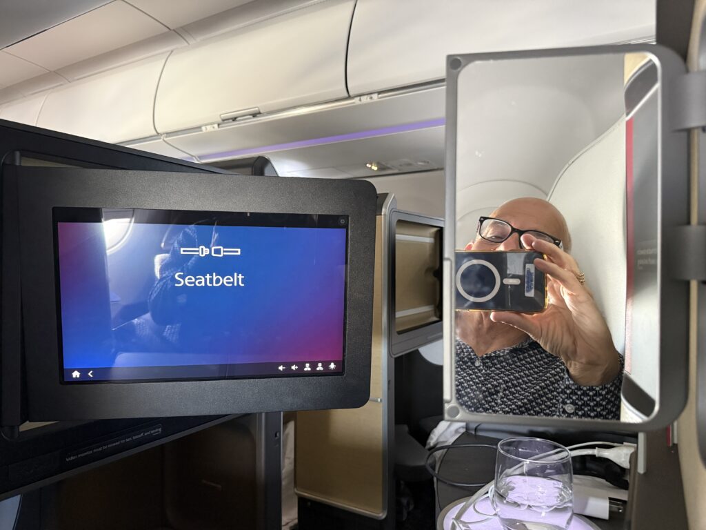 Passenger Control Unit in the suite is showing the seatbelt warning.