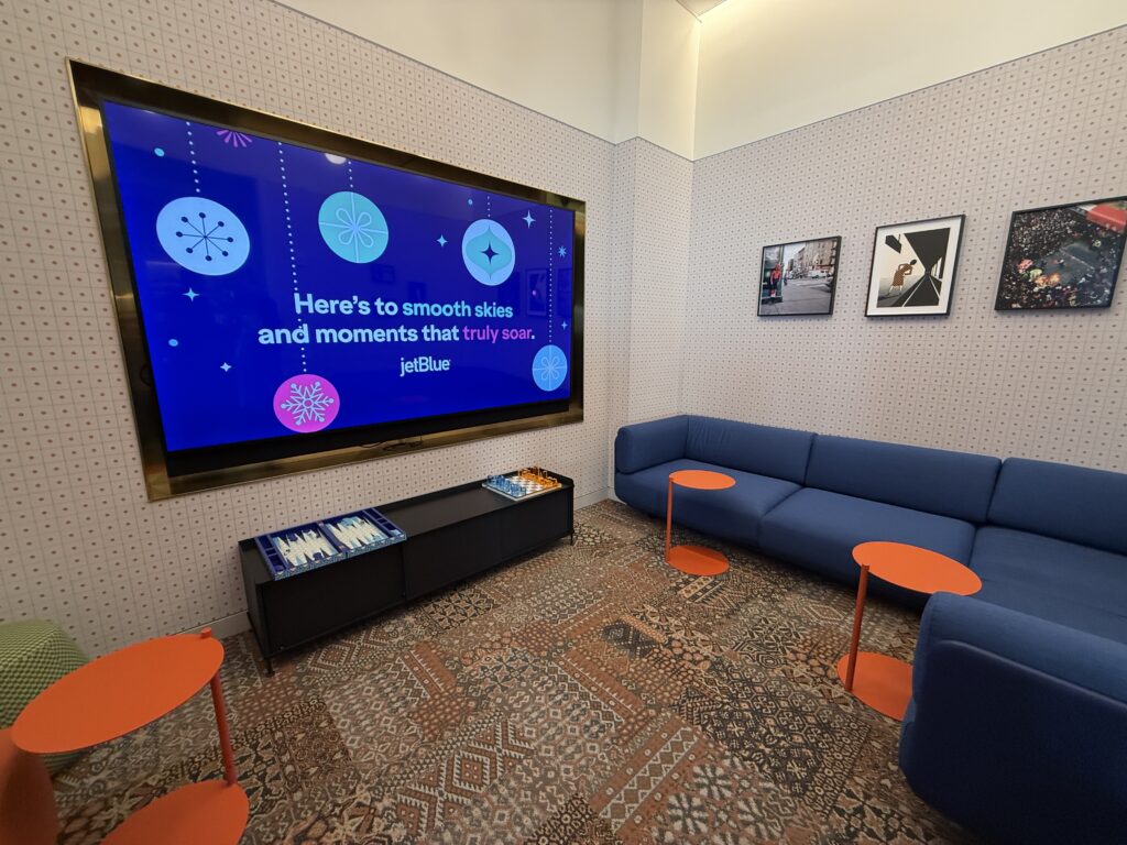 The downstairs level nook with board games also hosts a large TV screen.