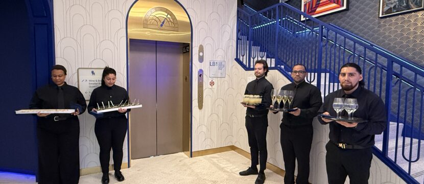 BlueHouse lounge staffers welcome guests with beverages at the entrance