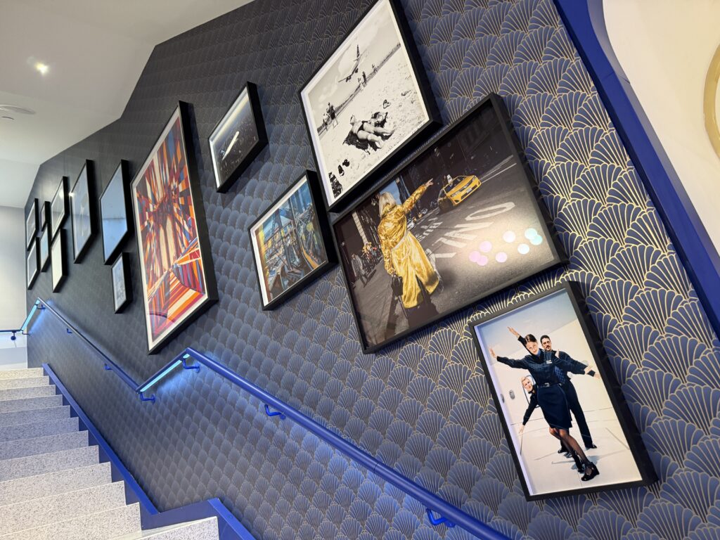 The stairwell is filled with various artwork.