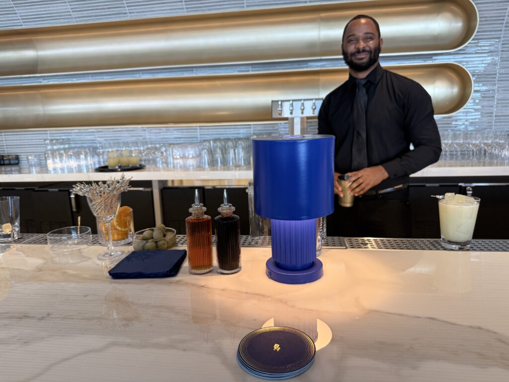 A BlueHouse bartender is ready to serve passengers.