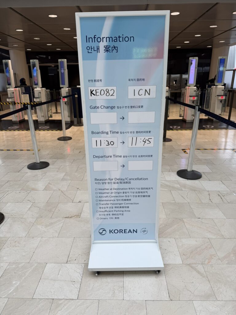 A board at the gate area that indicates the flight delay stats.