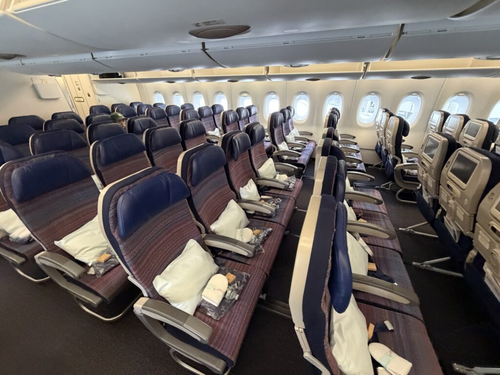 Korean Air A380 economy class section. Each seat is accompanied by a white pillow.