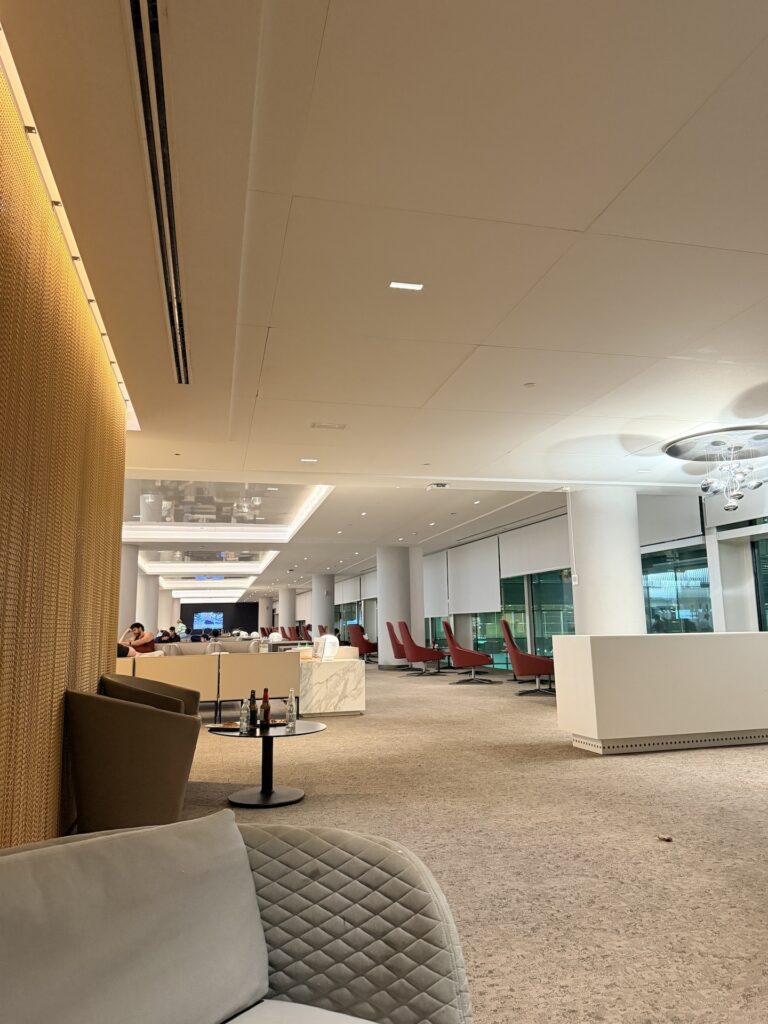 Barcelona Airport's Aena-operated Airport lounge is fairly empty with various seating options for passengers. 