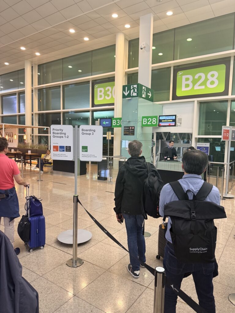 Passengers wait in line to board a Brussels Airlines flight at Barcelona Airport.