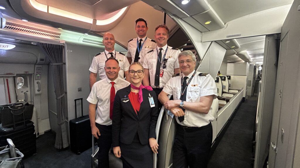 Crew members pose for a photo on the renewed Qantas A380.