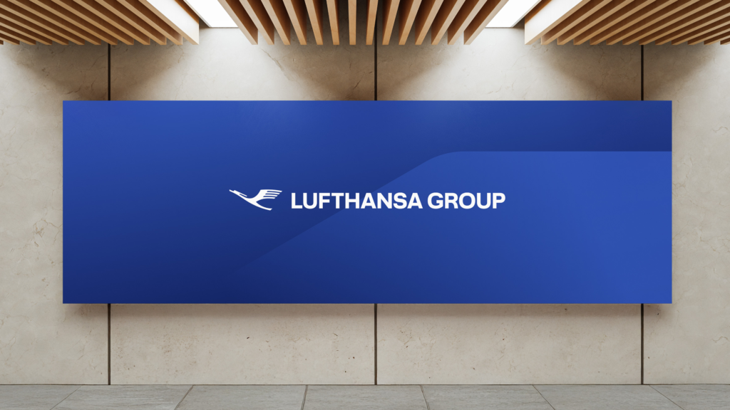 A dark blue back drop with the Lufthansa Group logo is displayed on a wall.