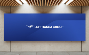 A dark blue back drop with the Lufthansa Group logo is displayed on a wall.