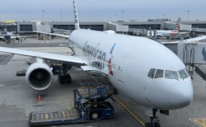 American Airlines Boeing 777-200 at the gate of JFK airport, supporting Flight AA142