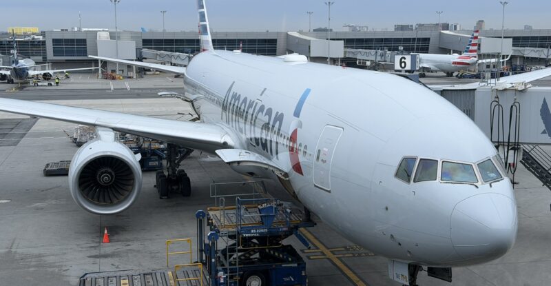 American Airlines Boeing 777-200 at the gate of JFK airport, supporting Flight AA142