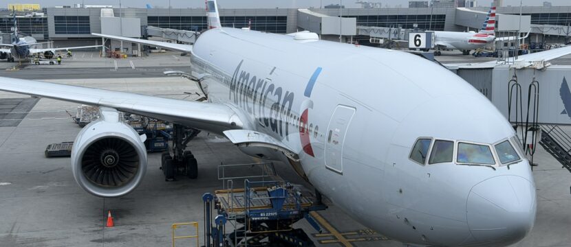 American Airlines Boeing 777-200 at the gate of JFK airport, supporting Flight AA142