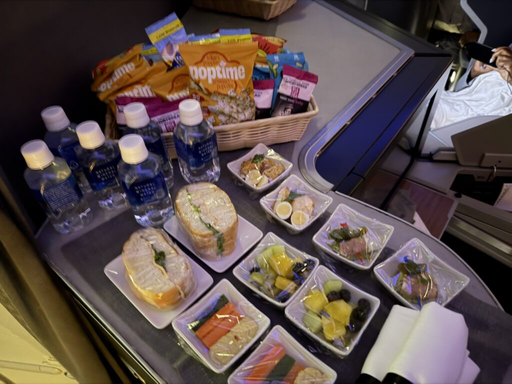 An assortment of snacks and water atop a monument.
