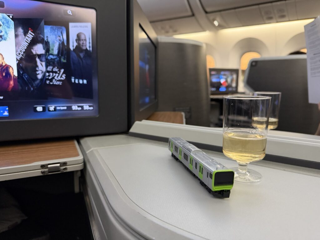 A glass of wine sits atop the side table in the mini-suite, without a napkin.