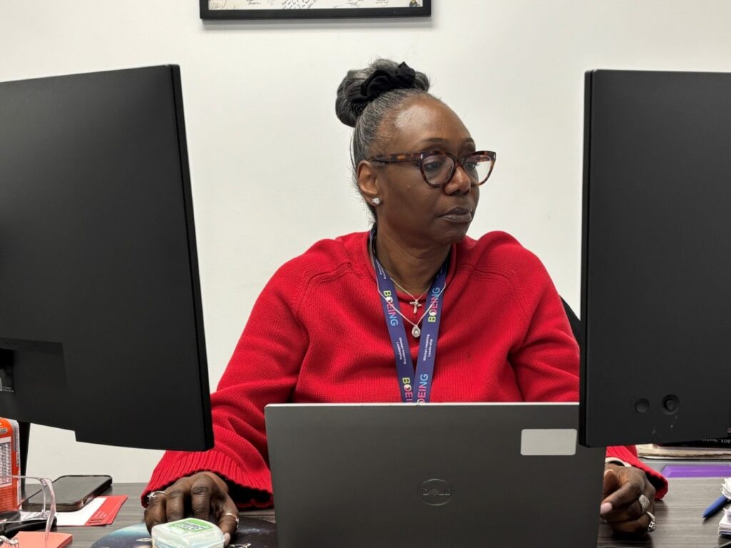 Cheryl Carter at work in front of multiple screens.