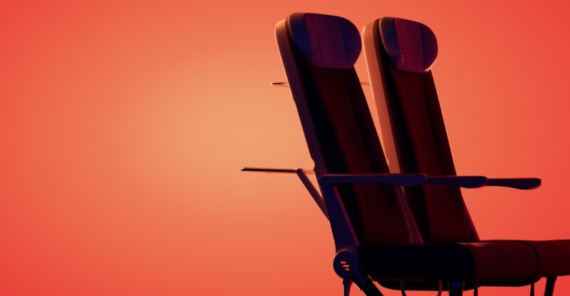 Two Expliseat aircraft seats on an orange-red background. The seats are being positioned as ideal for North American regionals.