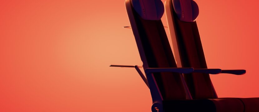 Two Expliseat aircraft seats on an orange-red background. The seats are being positioned as ideal for North American regionals.