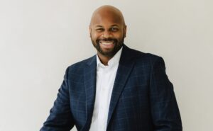 Bradley Akubuiro is a Partner at Bully Pulpit International and posing here for a photo.