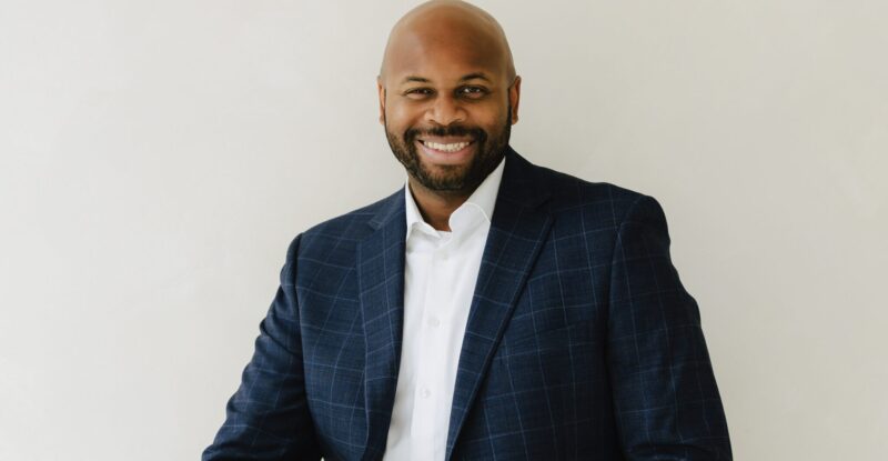 Bradley Akubuiro is a Partner at Bully Pulpit International and posing here for a photo.