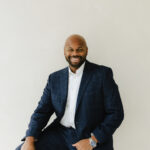 Bradley Akubuiro is a Partner at Bully Pulpit International and posing here for a photo.