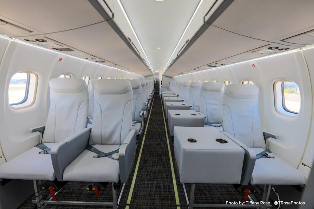 Inside the 2-1 configured JSX ATR 42-600. The CMF is light grey. Single seats on the left side are accompanied by a side table and two cup holders.