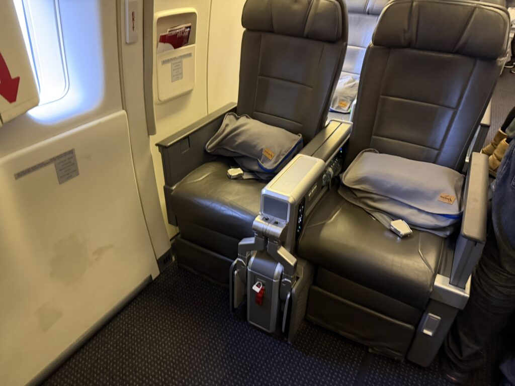 Two Premium Economy seats with no window directly beside them.
