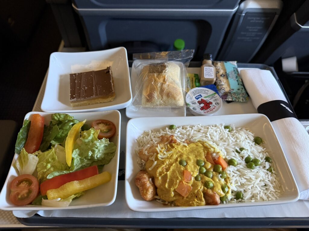 Chicken korma with basmati rice is served to the passenger in flight.