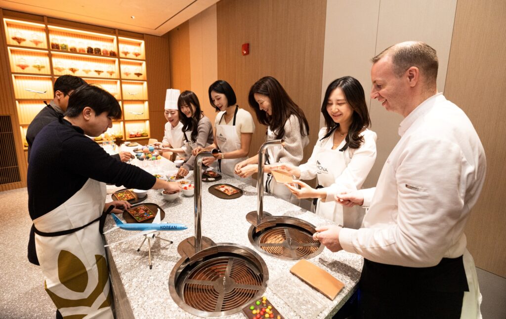 Passengers are enjoying the interactive culinary experiences at the Cooking Studio L'atelier.