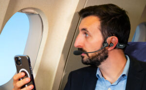 A passenger is seen here using a Skyted headset inflight.