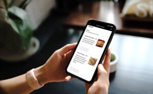 A passenger is looking at the United Pre Pay Bistro app on their mobile device.