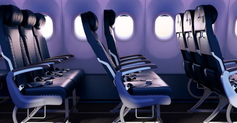 flynas cabin interior in economy class is dark blue with purplish blue mood lighting.