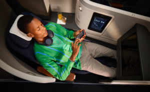 Lufthansa Allegris extra long bed is pictured with a tall passenger enjoying the space