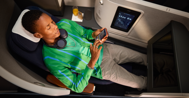 Lufthansa Allegris extra long bed is pictured with a tall passenger enjoying the space