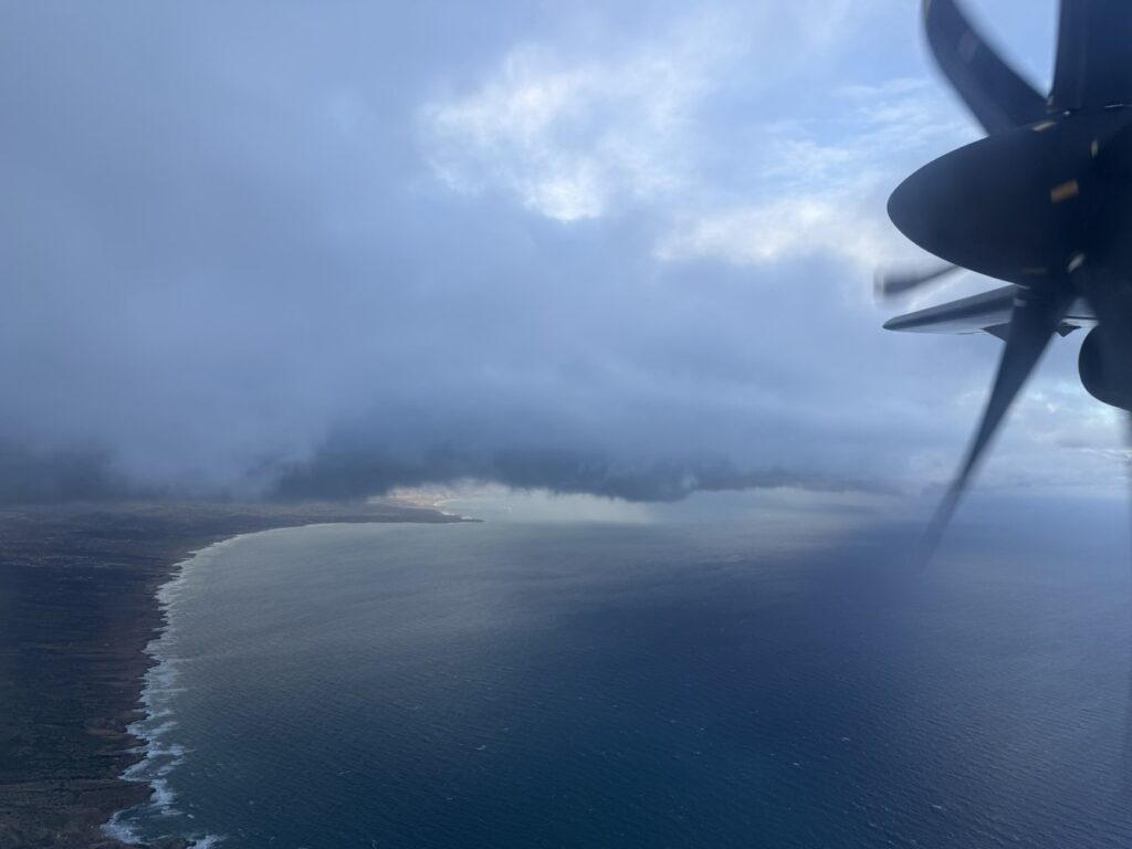 A beach scene is viewed out the window of the ATR